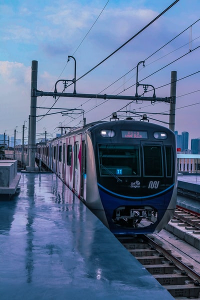 The blue on railway train during the day
